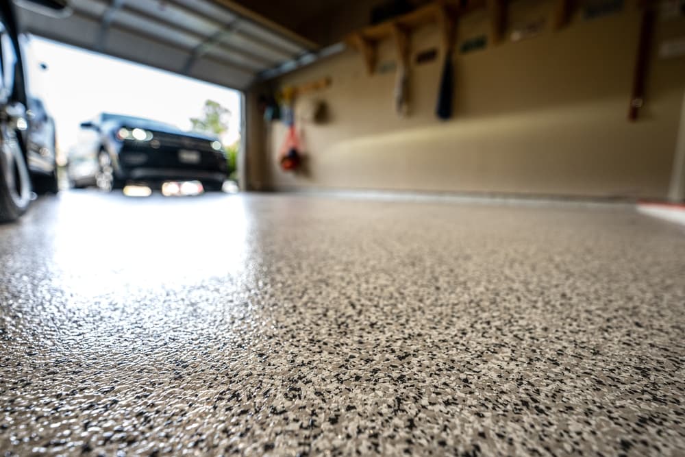 Glossy gray flake-chip coated garage floor with the Nevada foothills outside