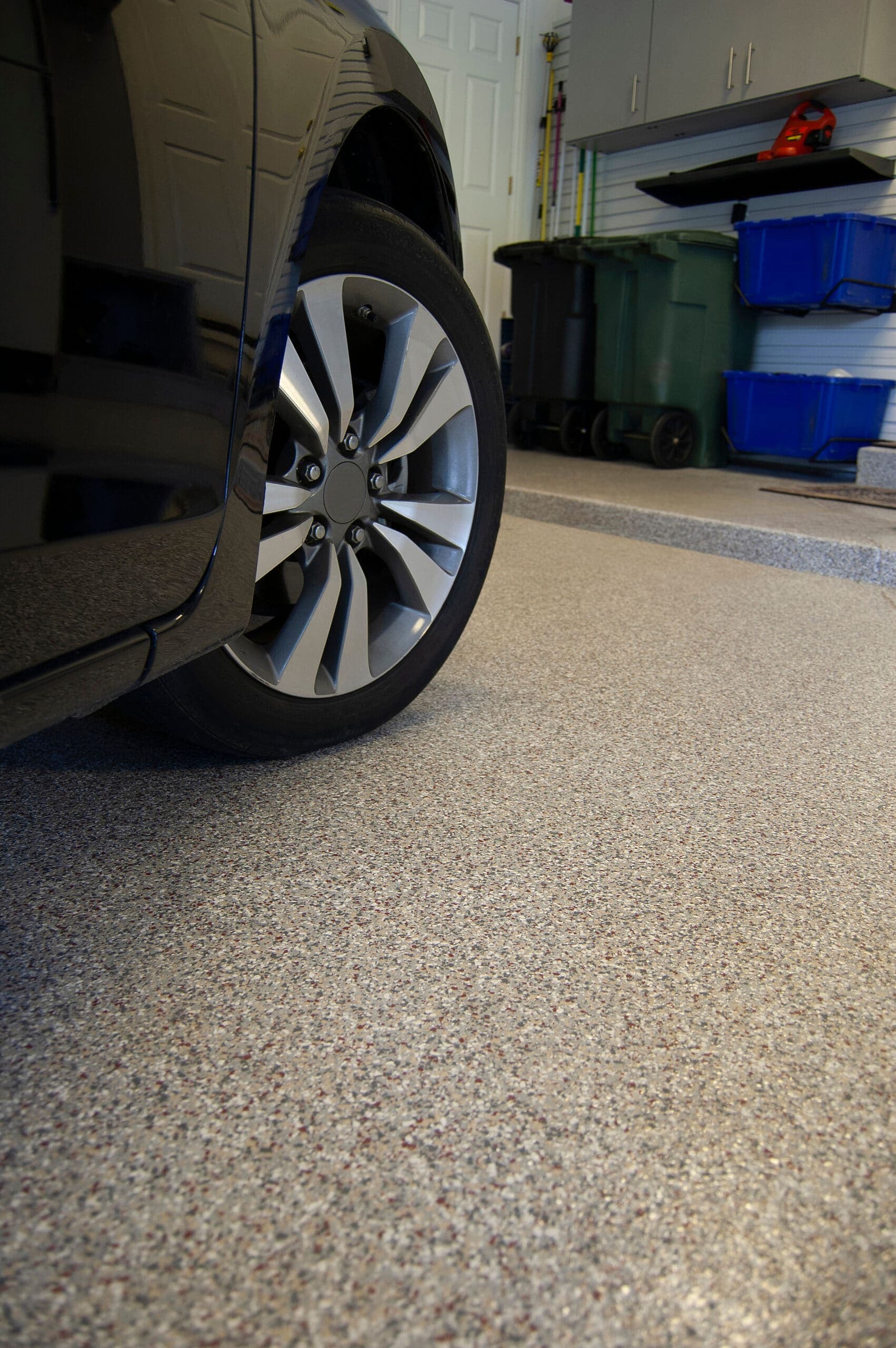 Car parked on a fresh flake-coated garage floor