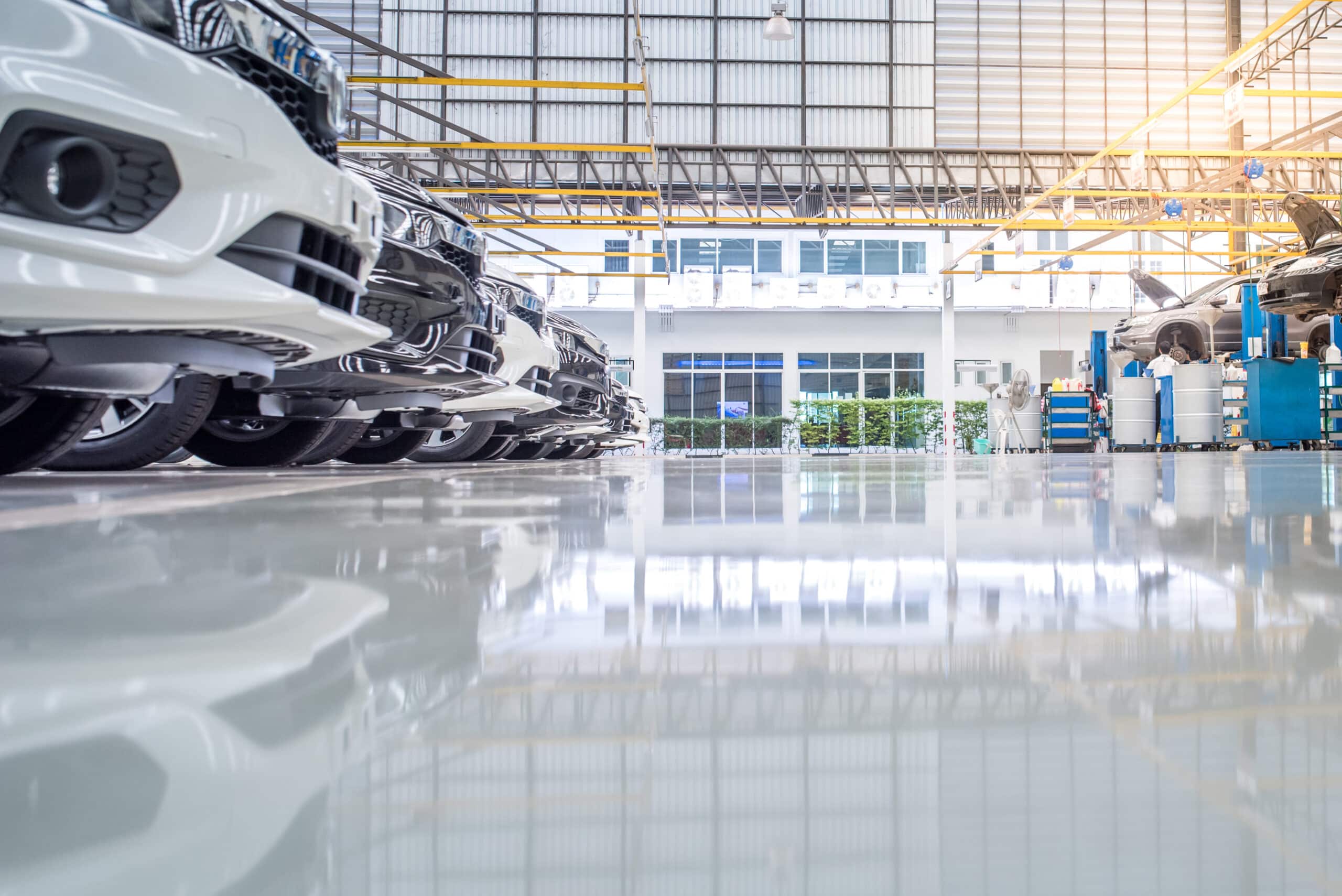 High-gloss coated showroom floor reflecting cars