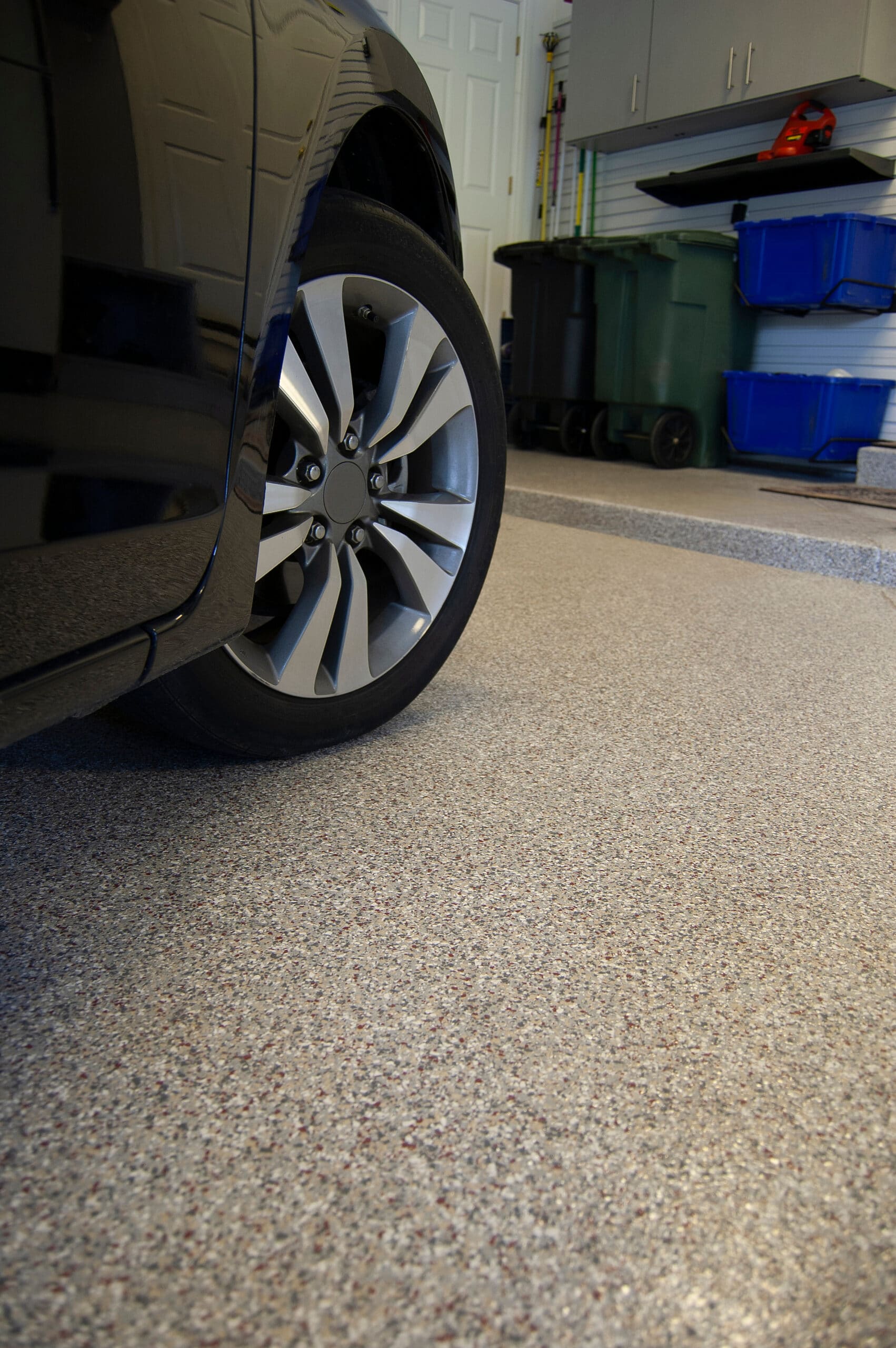 Car parked on a fresh flake-coated garage floor