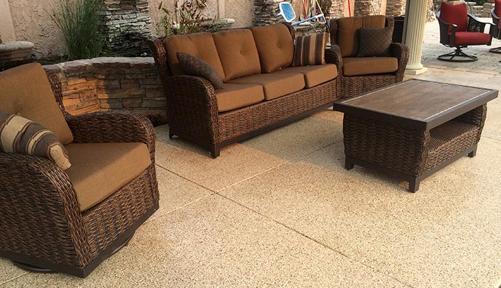 Covered patio with wicker furniture on a flake coated floor