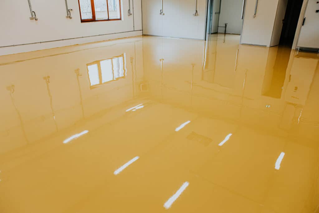 Shiny yellow epoxy floor in empty room