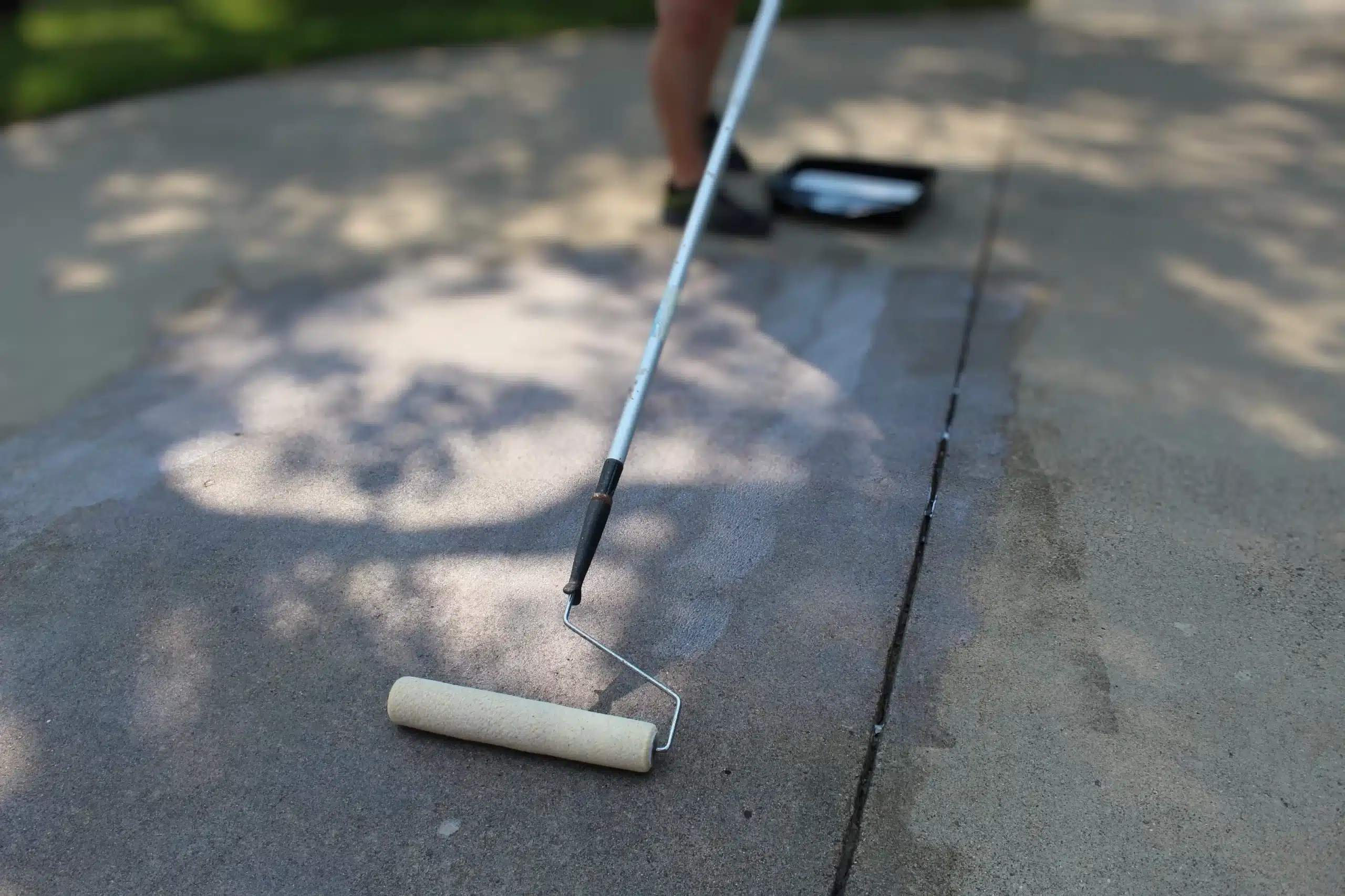 concrete driveway coating with roller.