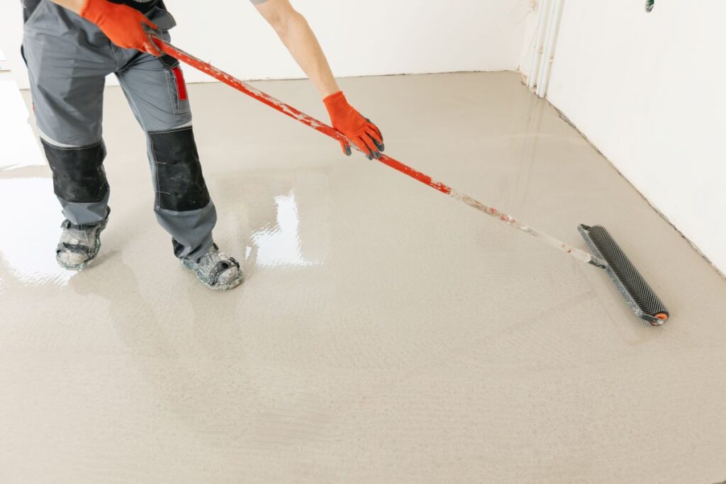 Worker applying needle roller to concrete coating in Reno, Nevada