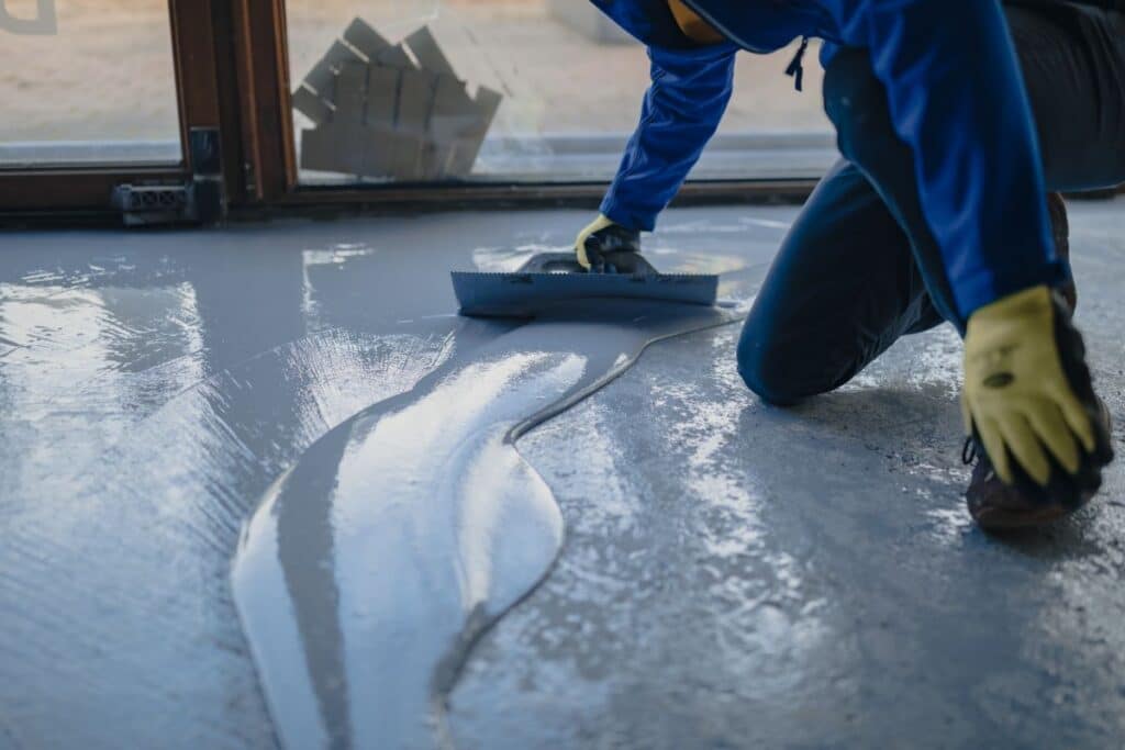 Worker applying epoxy floor coating in Reno, Nevada