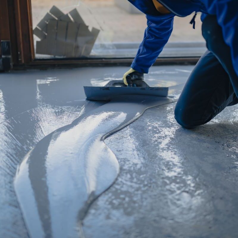 Worker applying epoxy floor coating in Reno, Nevada