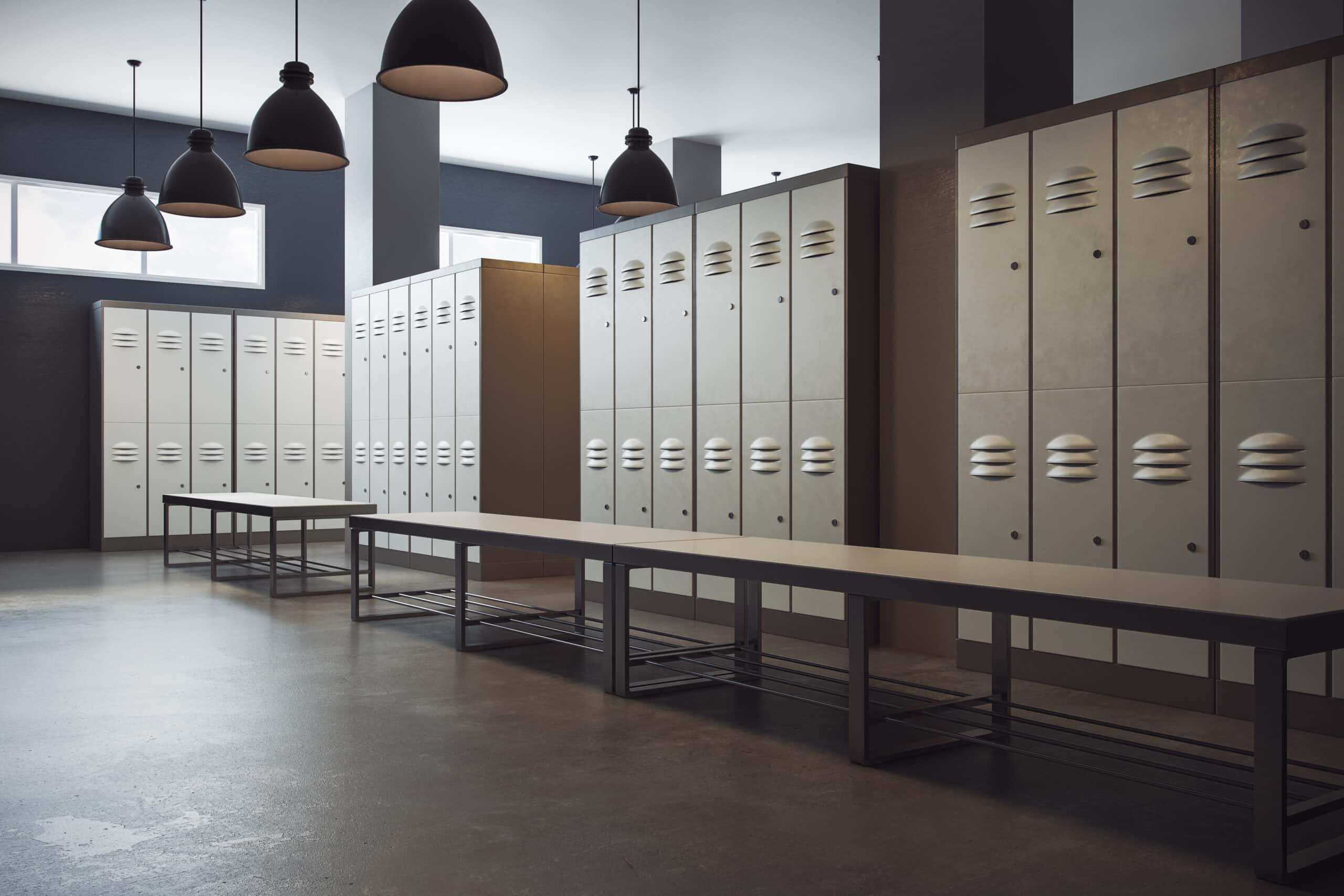 Empty locker room with benches and lockers.