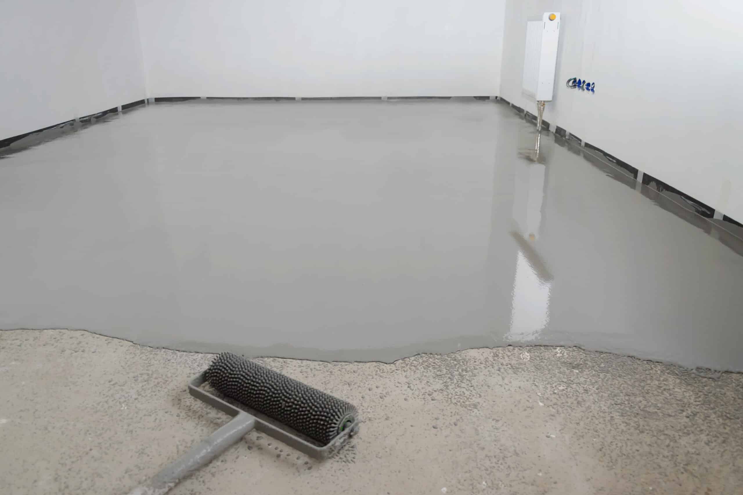 Freshly poured concrete floor leveling in progress.