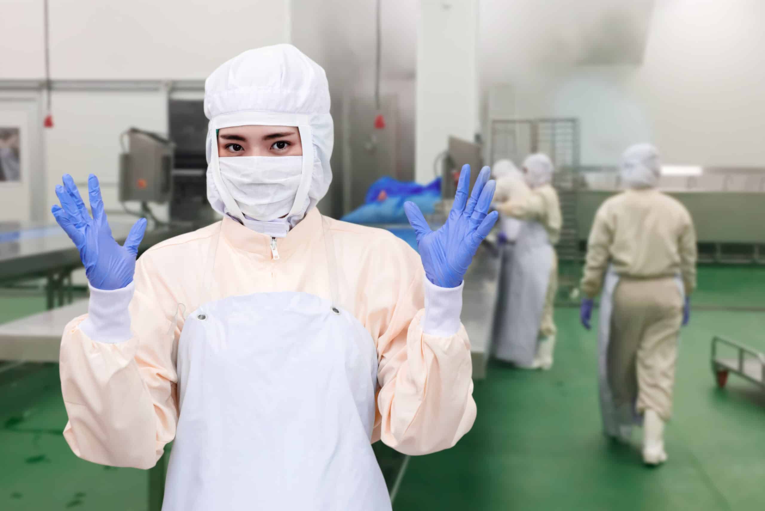 Worker in protective clothing in sterile environment