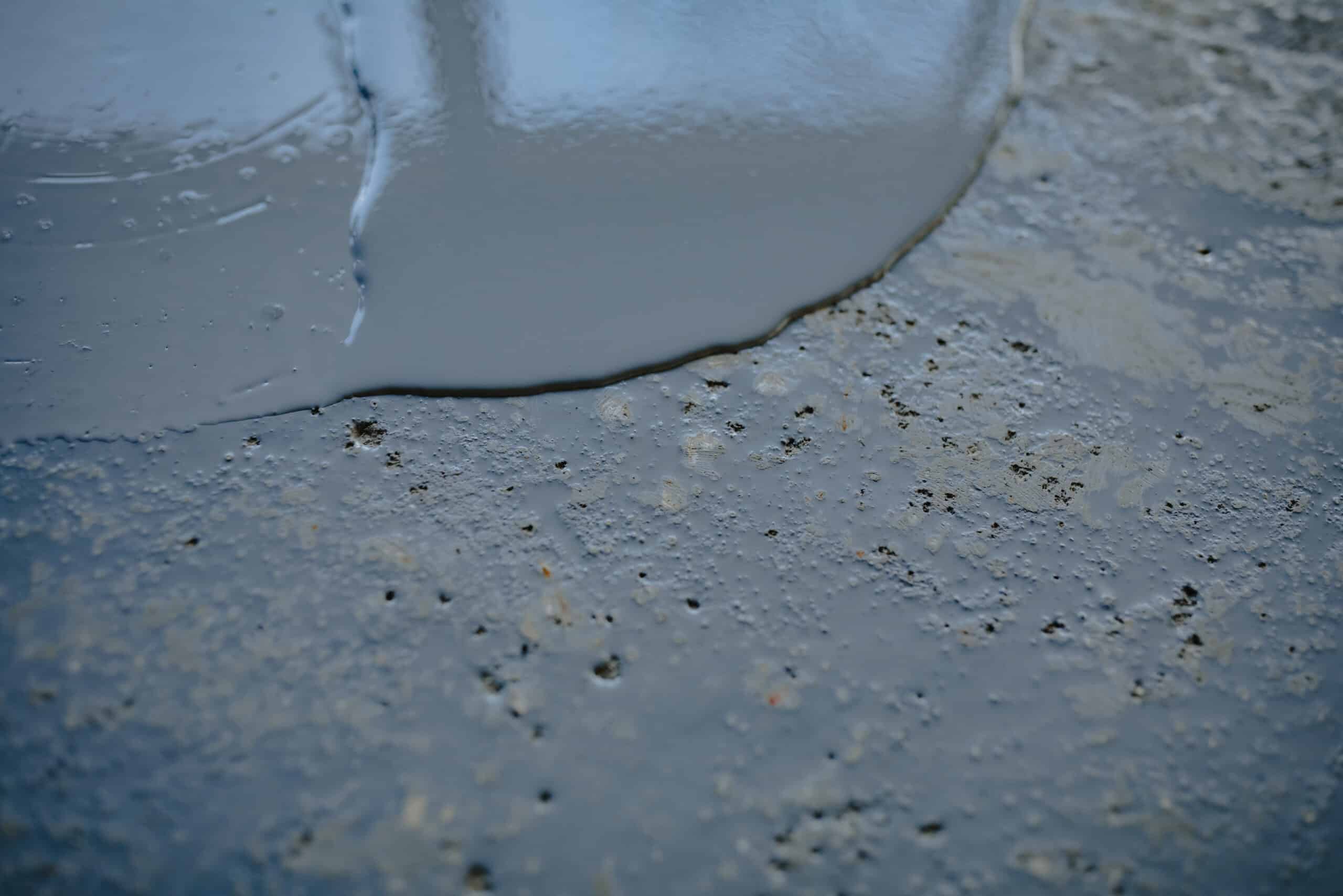 Fresh concrete being poured onto surface