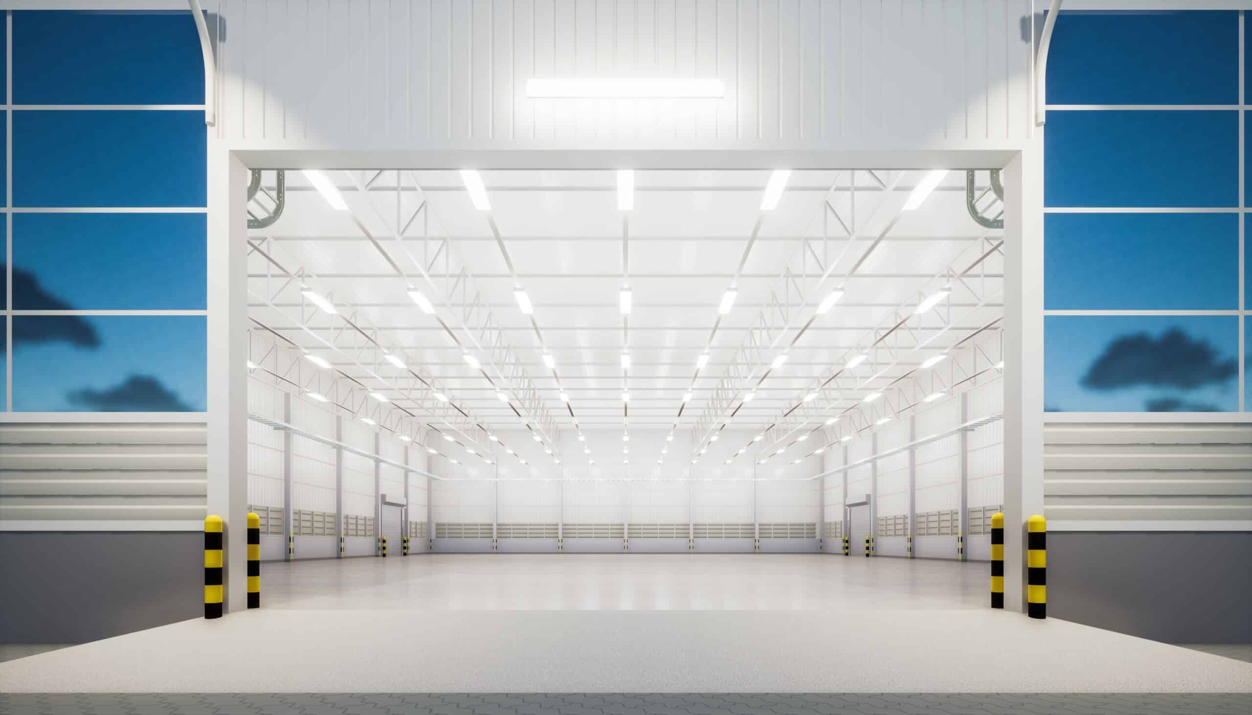 Large empty warehouse with open entrance and lights