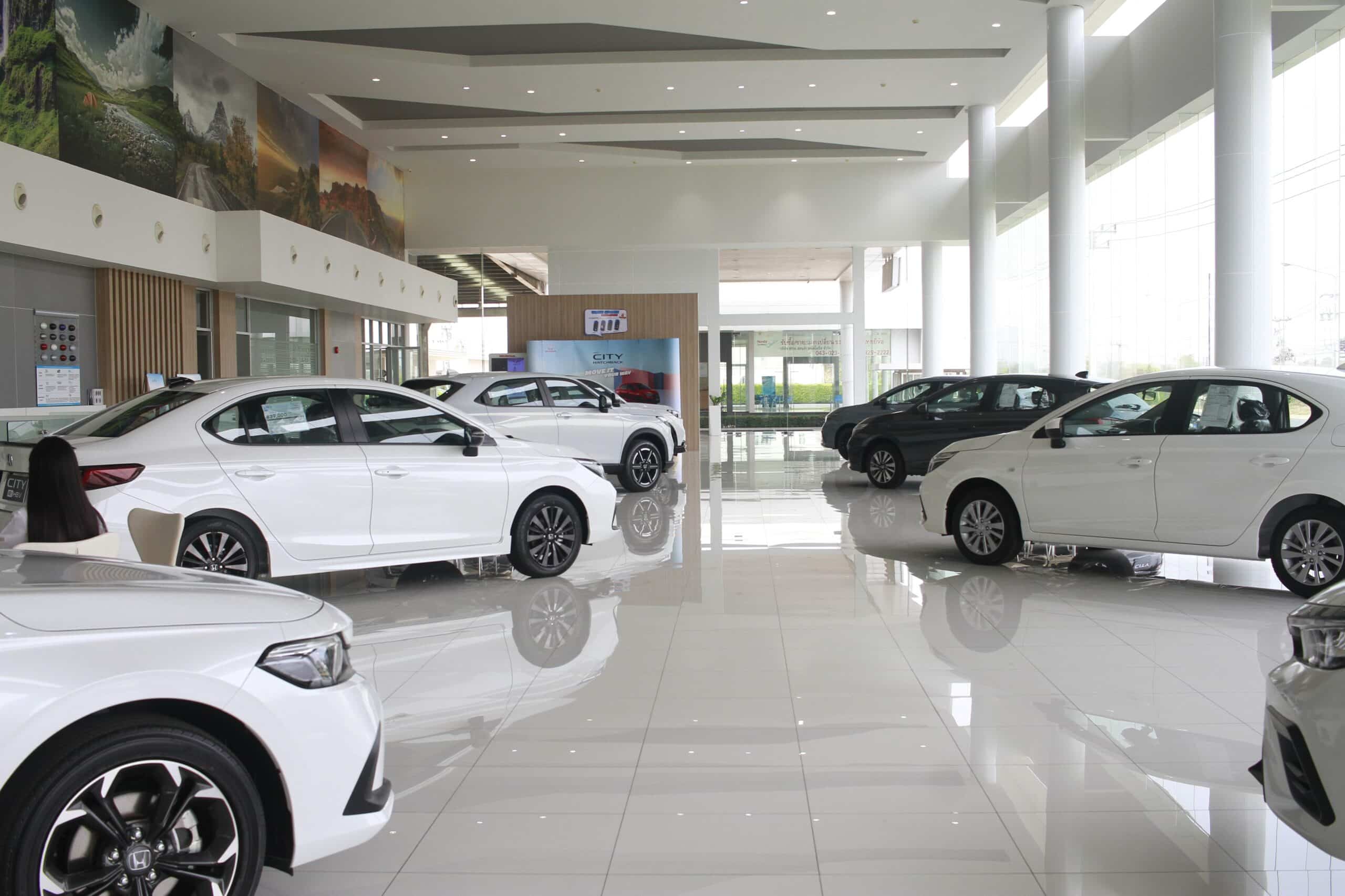 Modern car dealership showroom with multiple vehicles.