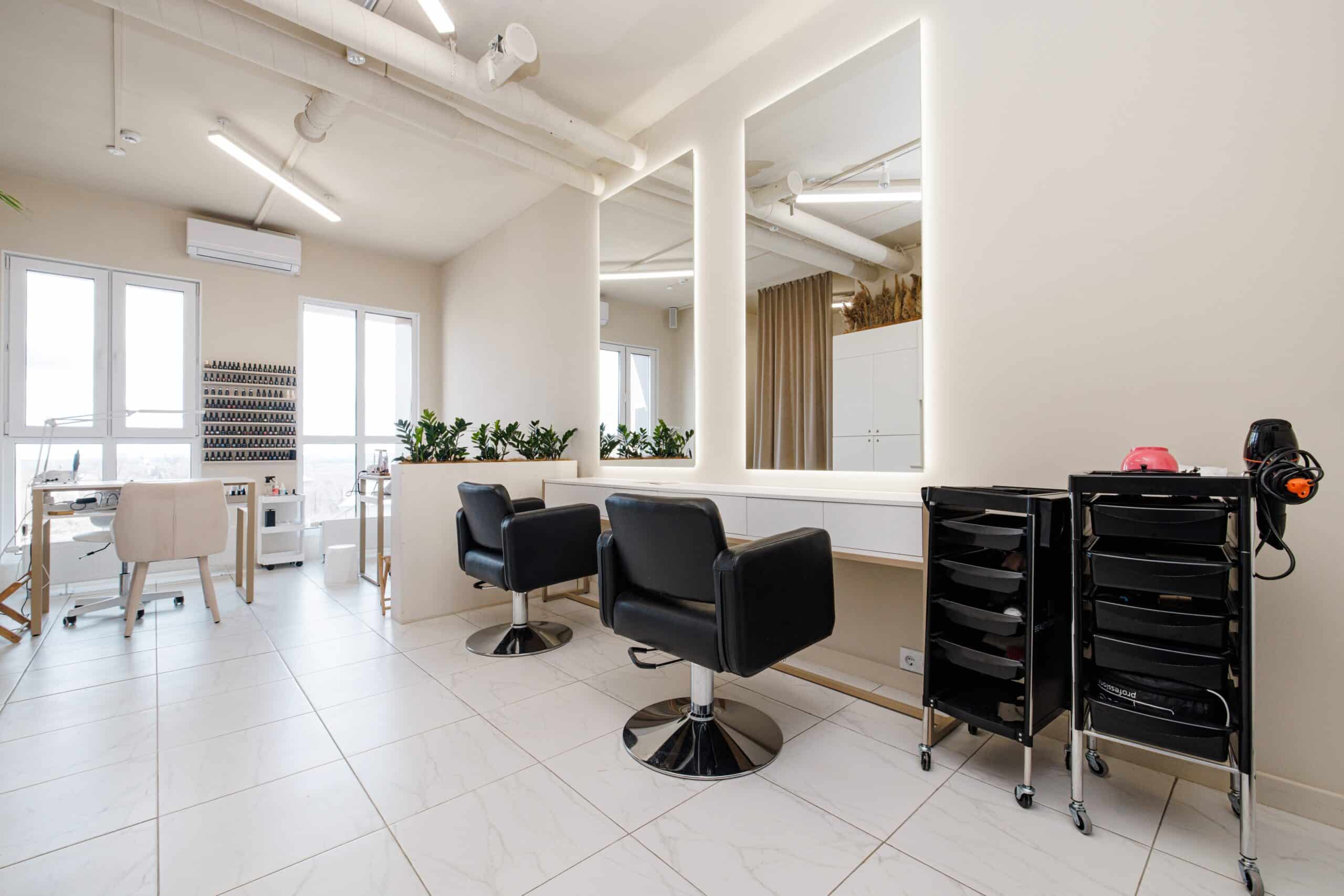 Modern hair salon with chairs and mirrors.