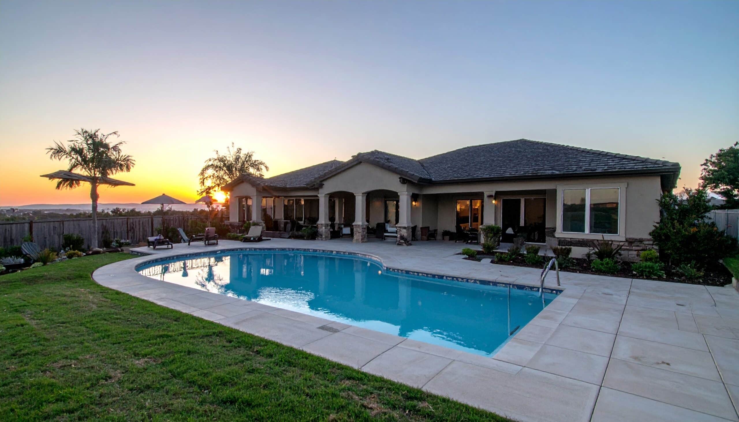 Luxury home with pool at sunset